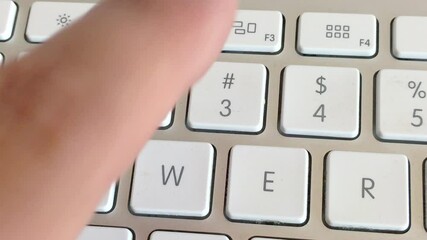 Typing a secret access password, human hand on a computer keyboard