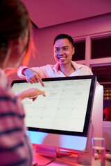Wall Mural - smiling business team planning meeting and choosing date and time in calendar on computer screen