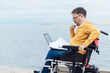 a man with disabilities in a wheelchair working with documents