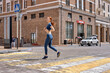 © Roman - Young woman running on road in city. Lifestyle morning run. Fitness and healthy lifestyle concept. Side view portrait on redhead lady in blue sportswear engaged in sport, jogging outdoors