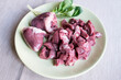 Raw turkey heart lies on a plate. Turkey by-products are sliced for cooking. Raw meat for pets. Hearts are one of the best sources of taurine you can feed your cat, dog, or ferret