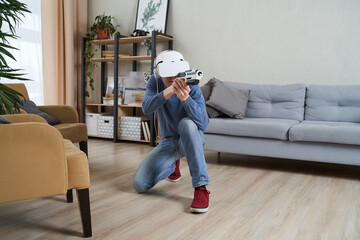 Wall Mural - man with virtual reality headset and blaster is playing game.