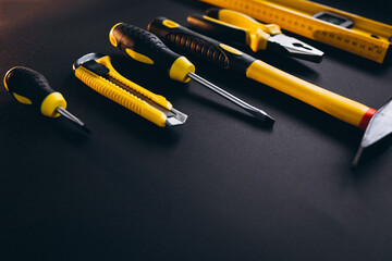 Wall Mural - Yellow set of tools on black background