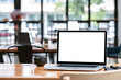 © NAMPIX - Mockup blank screen laptop computer on wooden table in cafe room.