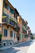Portrait Format View Of A Small Italian Town Showing Pastoral Buildings Shutters And Balconies