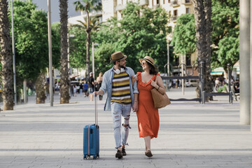 Happy hipster couple of tourist walking by the city at vacation holiday - Tourism and traveler people concept