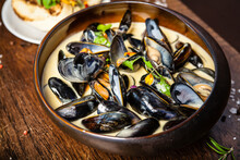 Blue Mussels In Cream Wine Sauce. Delicious Healthy Italian Traditional Food Closeup Served For Lunch In Modern Gourmet Cuisine Restaurant