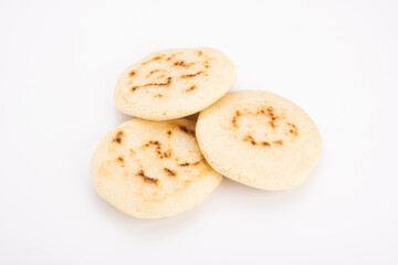 Wall Mural - Stack of arepas made with corn flour on a white background, typical Latin American food. They are generally eaten in countries such as Venezuela