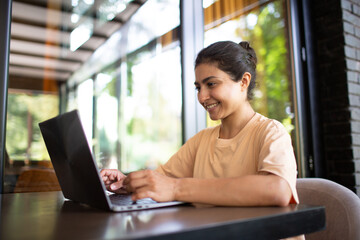 Indian business blogger vlogger woman working on her laptop outdoor