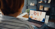 © tirachard - Young Asia girl using laptop video call meeting talk with elderly family dad and mom while work from home sitting on sofa at living room. Social distancing, quarantine for corona virus prevention.