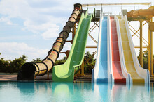 Beautiful View Of Water Park With Colorful Slides And Swimming Pool On Sunny Day