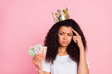 Poster - Photo of think curly hairdo young lady hold pills look wear crown t-shirt isolated on pink color background