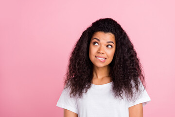 Poster - Photo of flirty wavy hairdo millennial lady look empty space bite lip wear white t-shirt isolated on pastel pink color background