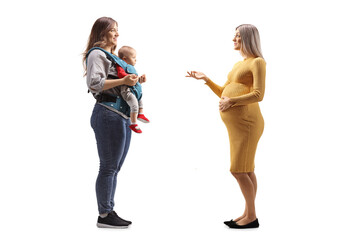 Poster - Full length profile shot of a young pregnant woman talking to a mother with a baby in a carrier