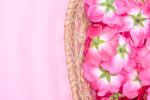 Closeup Of A Basket With Pink Flowers On An Aesthetic Pink Background.