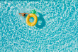 © Soloviova Liudmyla - Top view of a young female in swimsuit bikini in a straw hat on blue swimming pool waves background with big inflatable Yellow Pineapple tube. Chill out a summer vacation in luxury resorts concept.