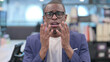 © stockbakers - Portrait of Disappointed Young African Businessman Reacting Loss