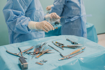 Wall Mural - Medical team preparing surgical equipment for operation inside emergency hospital clinic - Focus on left doctor hand