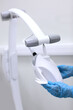 © Alla - Disinfection of dental equipment. Dentist assistant wipes dental teeth whitening equipment. Health care concept. Hands in protective gloves. Vertical photo.