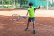© Anna - Boy in virtual reality glasses holding tennis racquet for tennis kick with help of online trainer. New reality of sport training