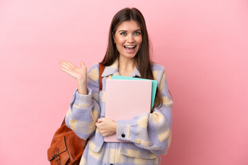 Wall Mural - Young student woman isolated on pink background with shocked facial expression