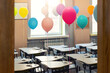 © Kirill Gorlov - Entrance door of empty elementary primary school interior furniture children desk decorated with multicolored colorful air balloons against window. Happy knowledge day and back to school concept