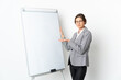 © luismolinero - Young Ireland woman isolated on white background giving a presentation on white board
