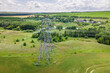 Overhead power line transmission tower at summer. Electricity pylon and High voltage grid tower with wire cable