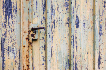 Poster - Closeup shot of a colorful washed door in blue and beige