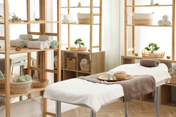 Sticker - Stylish room interior with massage table in spa salon