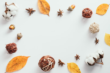 Wall Mural - Autumn flatlay composition. Frame made of dried leaves, decor, cotton on white background