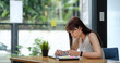 © Natee Meepian - Young Asian girl using smartphone buying online shopping by credit card at home. Lifestyle woman at house concept