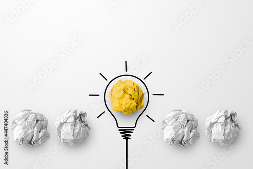 Concept creative idea and innovation. Paper scrap ball yellow colour outstanding different group with light bulb symbol