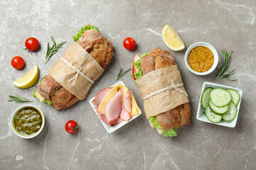 Wall Mural - Concept of tasty eating with ciabatta sandwiches on gray textured table