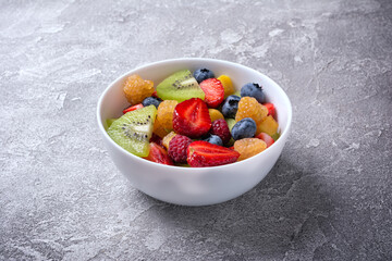 Wall Mural - Bowl of healthy salad with fresh fruits and berries