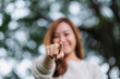 © Farknot Architect - Blurred image of a beautiful young asian woman pointing finger to the camera in the park