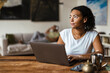 © Drobot Dean - Woman with vitiligo working with laptop while sitting at table in home