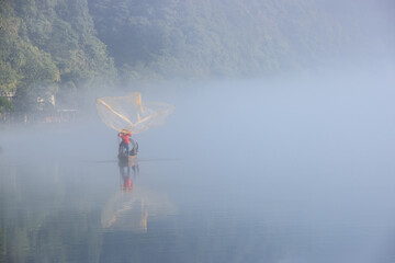 Poster - casting fishing net closeup on mist river