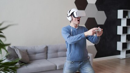 Wall Mural - man is playing game with virtual reality headset and joystick