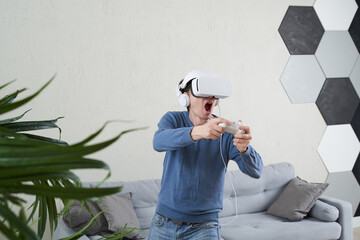 Wall Mural - man with virtual reality headset is playing game.