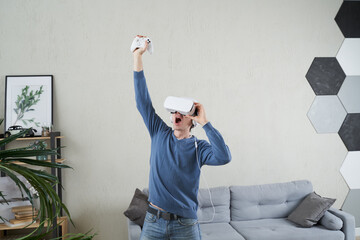 Wall Mural - man with virtual reality headset is playing game.