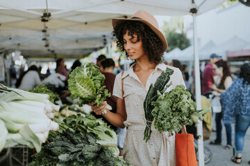 Wall Mural - Beautiful woman buying kale at a farmers market