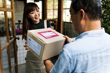 Woman Receiving A Box Delivered To Her