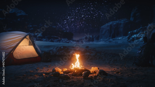 People Camping at Night in the Canyon, Preparing to Sleep in the Tent. Campfire Burning. Amazing Natural Landscape View with Marvelous Bright Milky Way Stars Shining on Mountains.