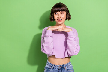 Canvas Print - Portrait of attractive bewildered girl thinking looking aside copy space isolated over vibrant green color background