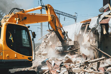 Destruction Of Old House By Excavator. Bucket Of Excavator Breaks Concrete Structure.