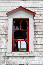 Broken Window With Peeling Painted Walls Of A Broken Down Lighthouse