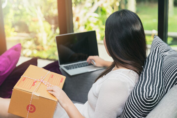 Successful entrepreneur business woman with online sales and Parcel shipping in her home office, prepare parcel box of product for deliver to customer.