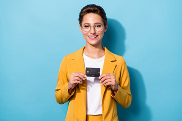 Canvas Print - Photo portrait woman wearing yellow blazer spectacles showing credit card isolated pastel blue color background