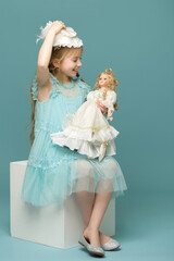 cute little girl playing with a doll.